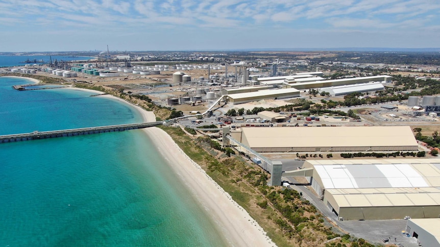 Buildings in the Kwinana industrial area leading down to the ocean.