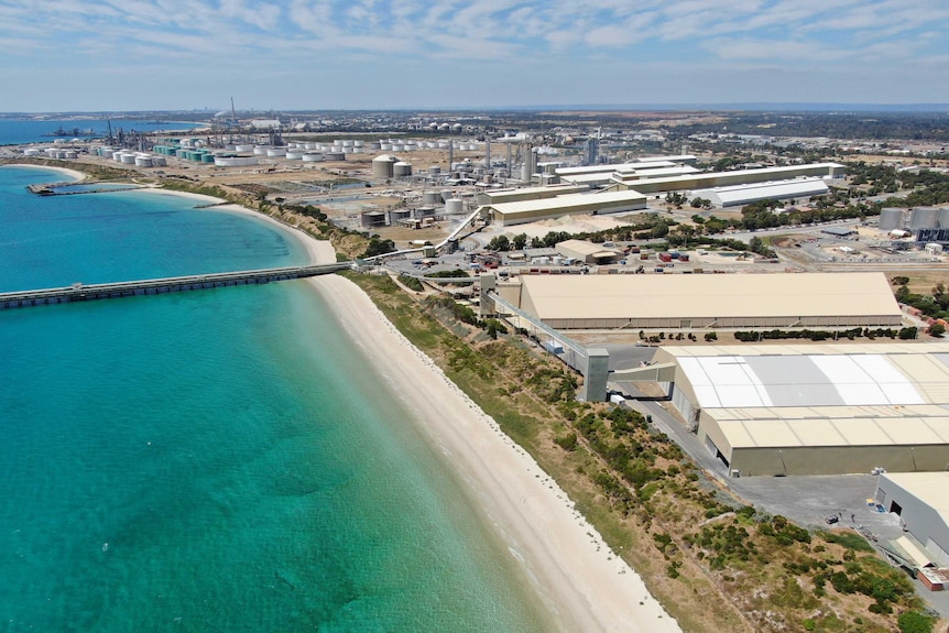 Buildings in the Kwinana industrial area leading down to the ocean.