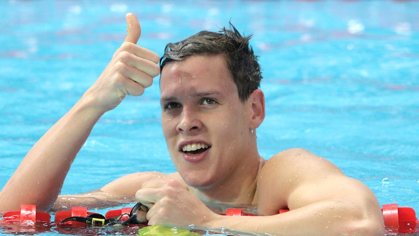 Mitch Larkin celebrates after the 100m backstroke heats