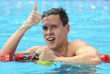 Mitch Larkin celebrates after the 100m backstroke heats