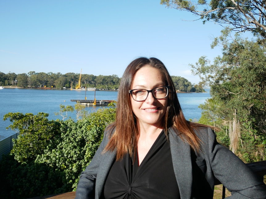 Jasmine Person on her deck with the bay in the background.