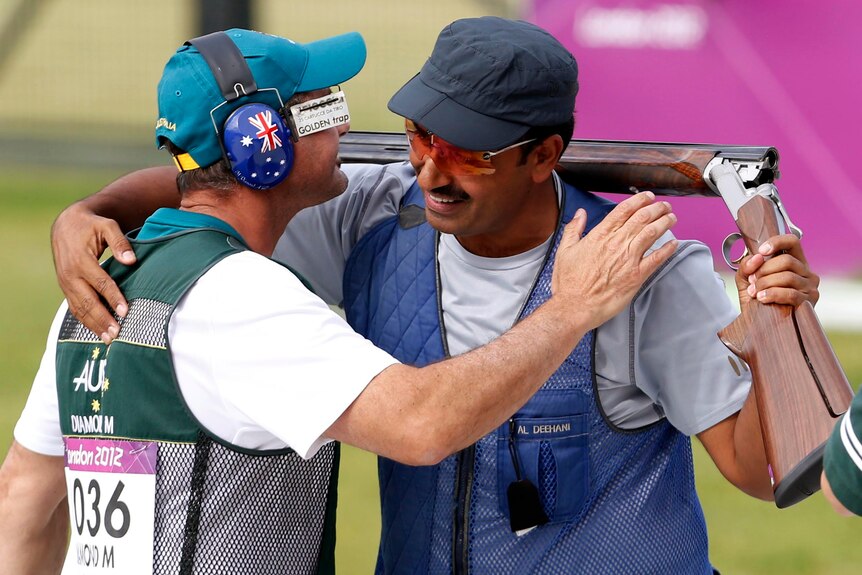 Fehaid Aldeehani is congratulated by Michael Diamond after placing third in the trap shooting final.