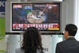 South Koreans watch a North rocket launch