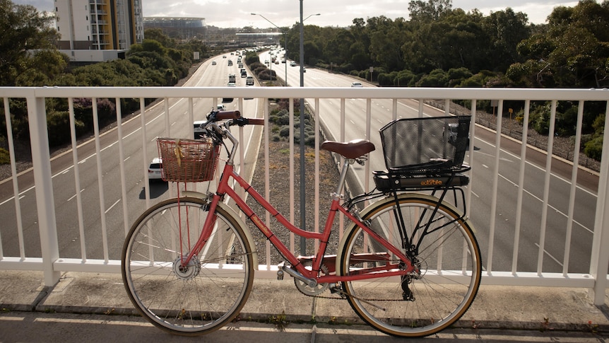 An e-bike on an overpass with freeway in background