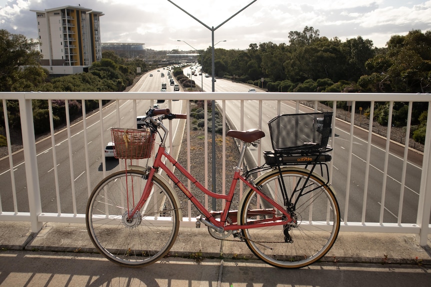 An e-bike on an overpass with freeway in background
