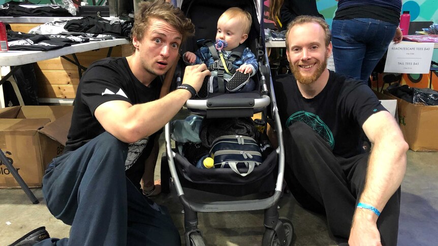 JP Gauntlett and David Reilly sit on either side of a pram