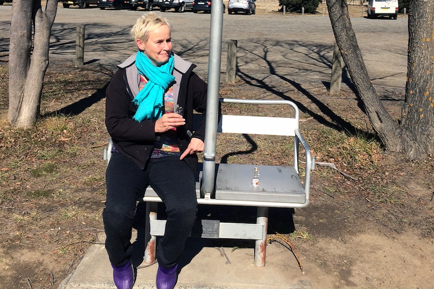 Wendy Hukins toasting Oskar Luhn on his memorial chair at Jindabyne.