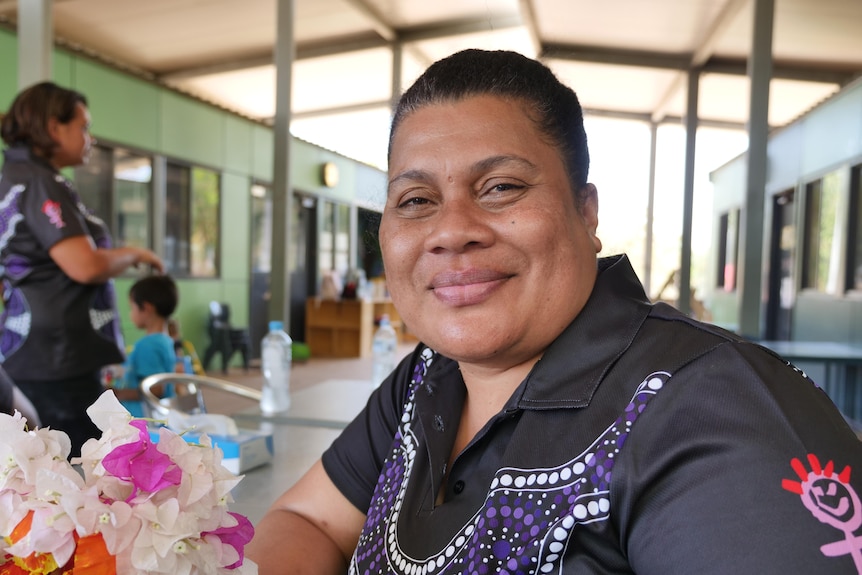 A woman smiles at a childcare centre