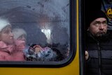 Ukraine evacuees wait on a bus