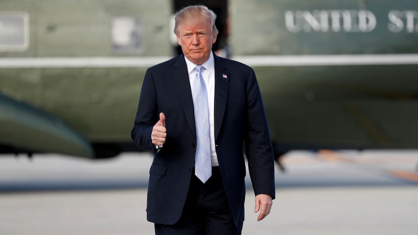 Donald Trump gives the thumbs up outside Marine One