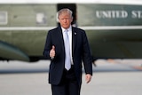 Donald Trump gives the thumbs up outside Marine One