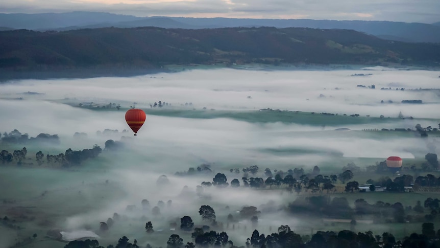 a hot air balloon in a misty sky
