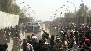 Hundreds killed: Ambulances rush towards the bridge following the stampede.