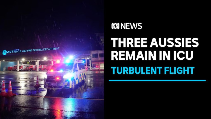 Three Aussies Remain in ICU, Turbulent Flight: An ambulance with its sirens on on an airport tarmac at night in the rain.