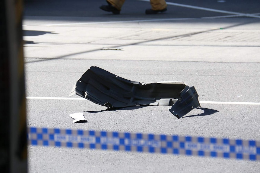 A part of a white 4WD after it crashed through a pedestrian crossing on Flinders Street.