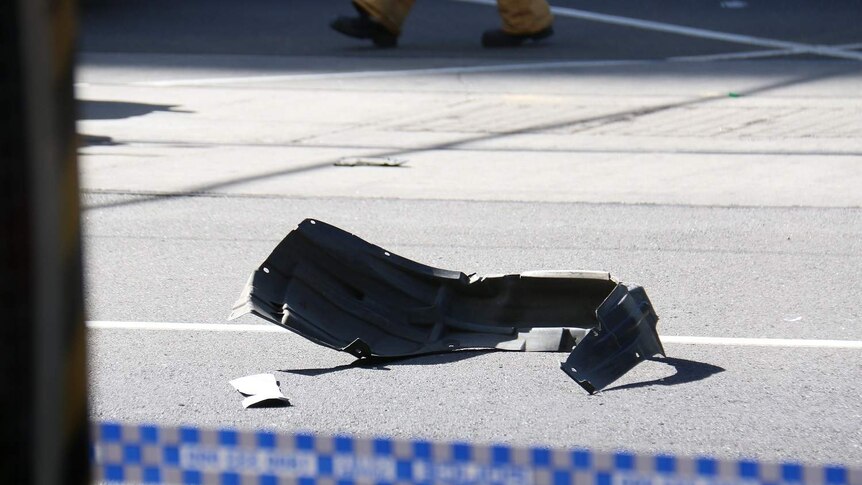 A part of a white 4WD after it crashed through a pedestrian crossing on Flinders Street.