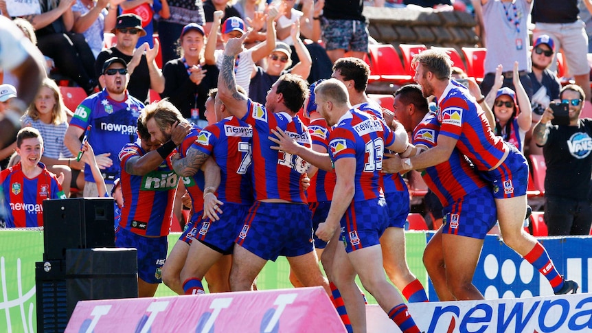 Nathan Ross (L) and the Knights celebrate try against Gold Coast at Hunter Stadium in round 2, 2017.