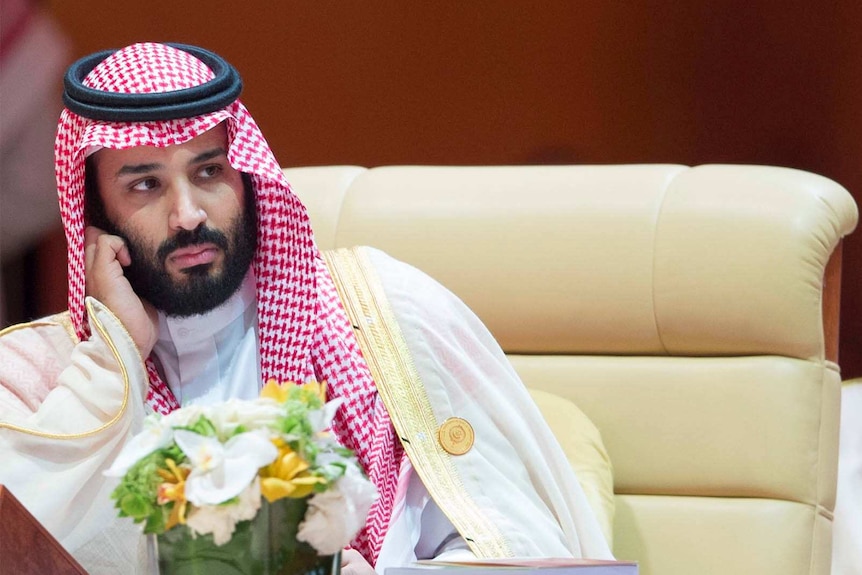 Crown Prince Mohammed bin Salman rests his head on his hand at the 29th Arab Summit