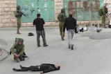 An Israeli soldier shot dead a subdued Palestinian attacker