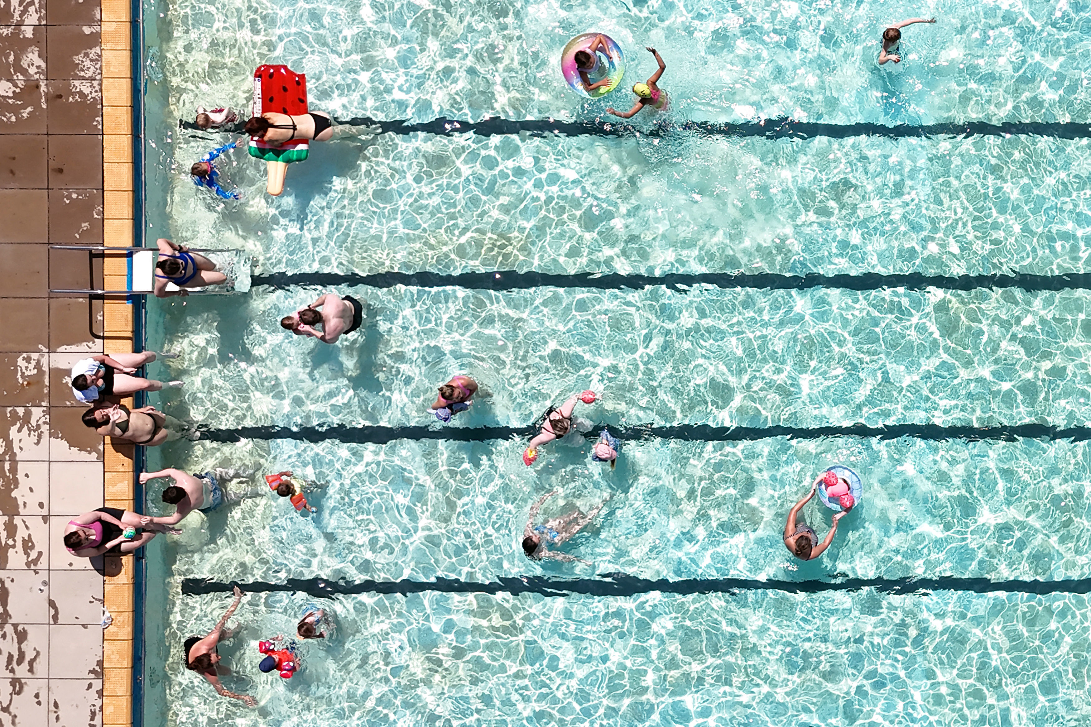 An aerial view of a busy public pool.