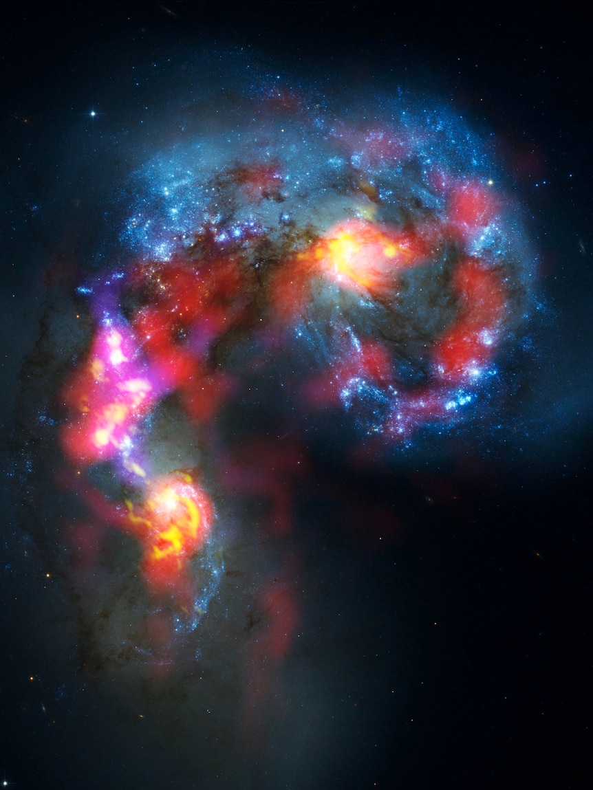 The Antennae Galaxies, a pair of distorted colliding spiral galaxies about 70 million light-years away