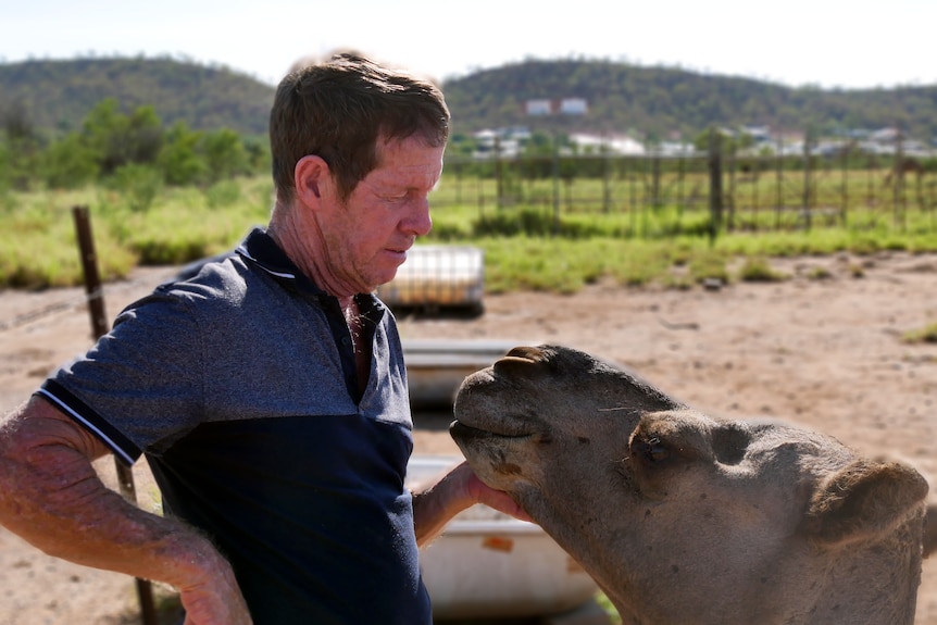 Paul Keegan patting a camel