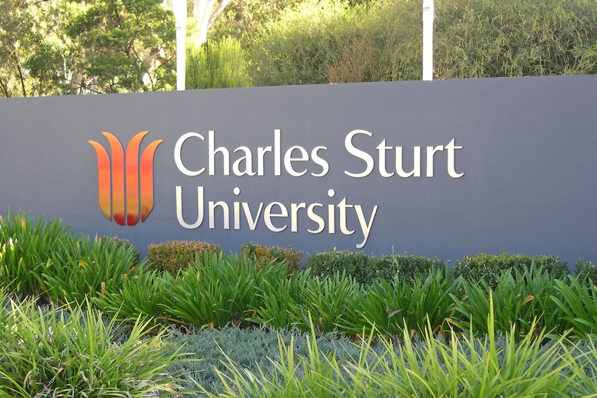 A sign on campus says 'Charles Sturt University'.
