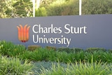 A sign on campus says 'Charles Sturt University'.