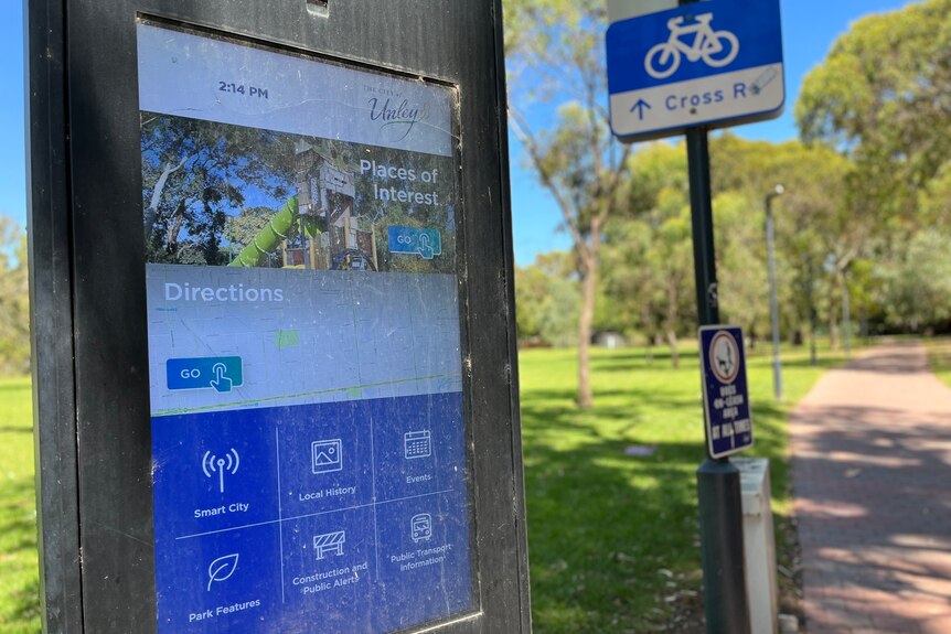 A touch screen in a park where you can press for directions and other services