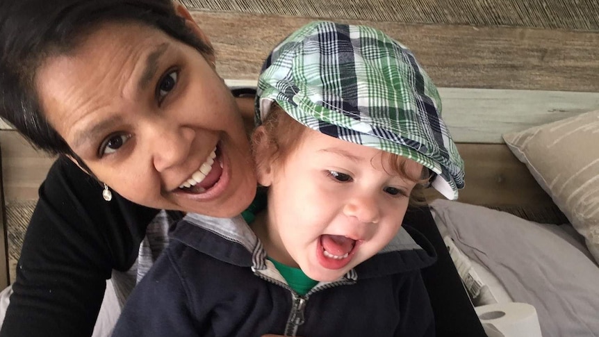 Smiling woman holding toddler