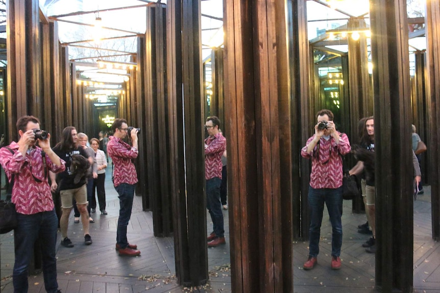 Multiple images of the photographer in a house of mirrors