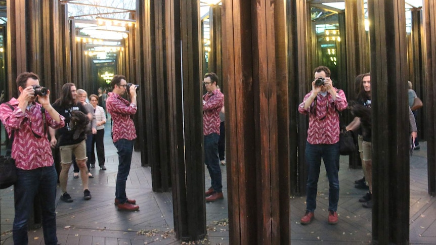 Multiple images of the photographer in a house of mirrors