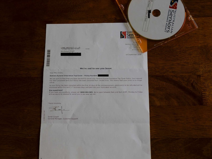 A letter detailing the policy cancellation of Robyn O'Neill's funeral insurance and a CD sit on a table.