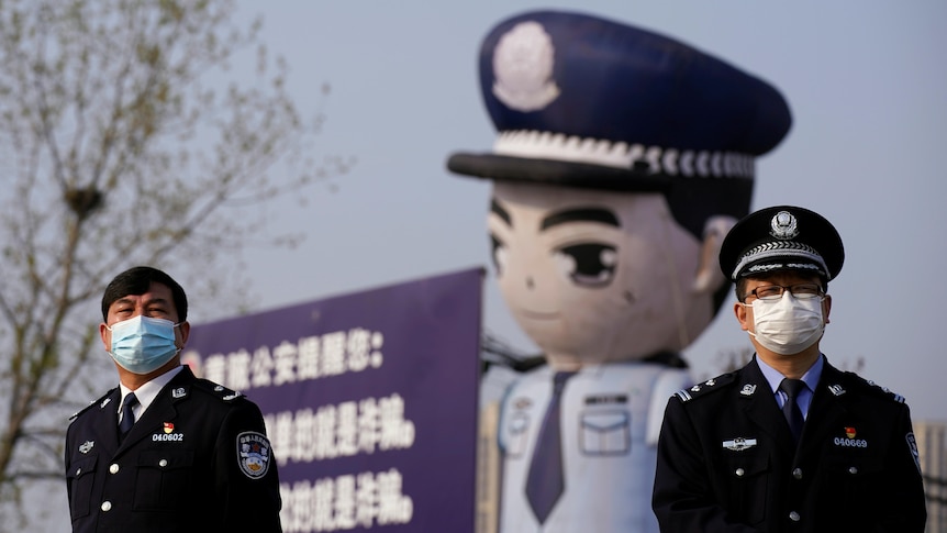 Two police men standing on the street of Beijing.