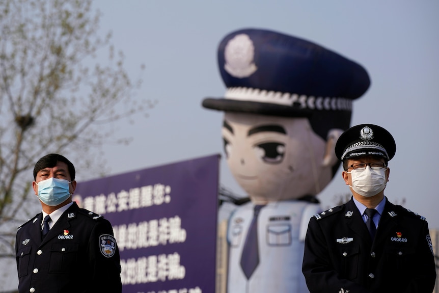 Two police men standing on the street of Beijing.