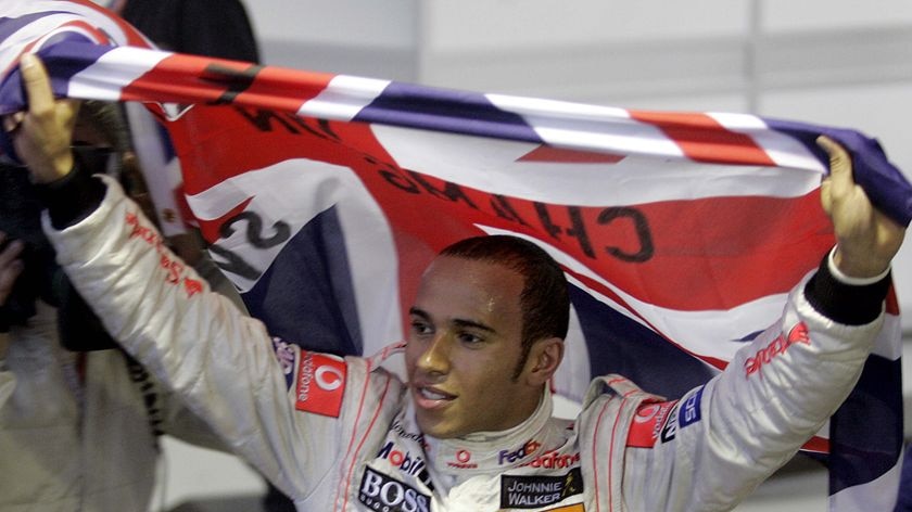 Lewis Hamilton celebrates after winning the 2008 FIA Formula One Championship