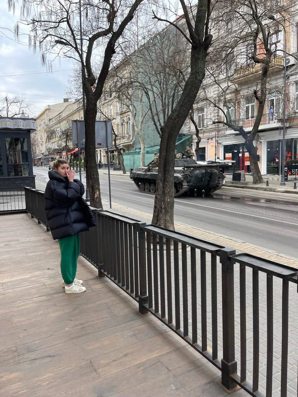 An army tank drives in an Odesa street.