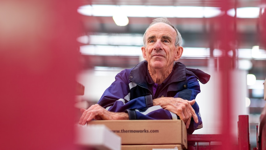 Barry Foreman leans on a box inside a Fedex warehouse