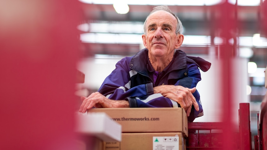 Barry Foreman leans on a box inside a Fedex warehouse