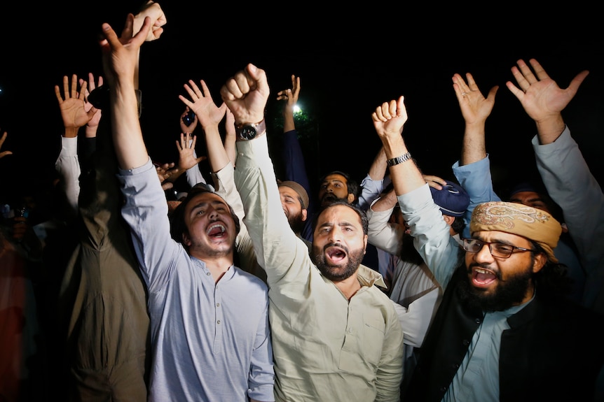 Men cheer with their arms in the air