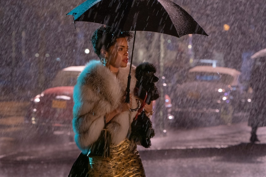 Film still of Andra Day as Billie Holiday under an umbrella from The United States vs Billie Holiday