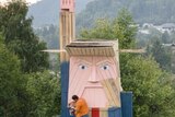 People work on a wooden statue made to resemble US President Donald Trump in the village of Sela pri Kamniku.