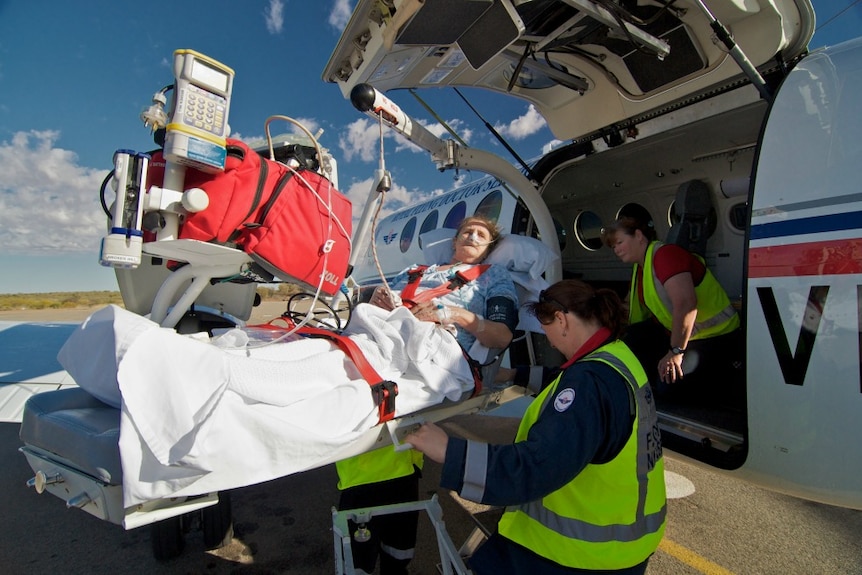RFDS medical staff load a patient onto an aircraft