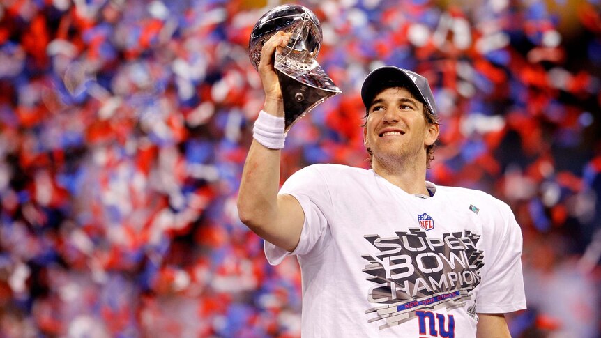 New York Giants quarterback Eli Manning holds the Vince Lombardi Trophy