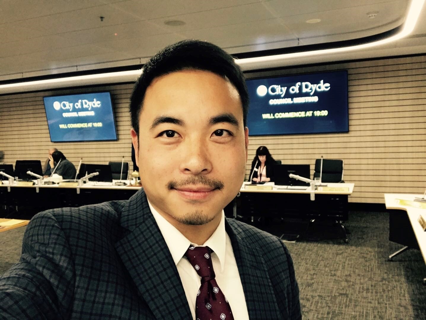 A portrait photo of a man looking at the camera.  