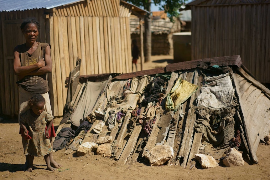 A photo of Julienne and Telodoza near a dusty structure covered in rocks and material.