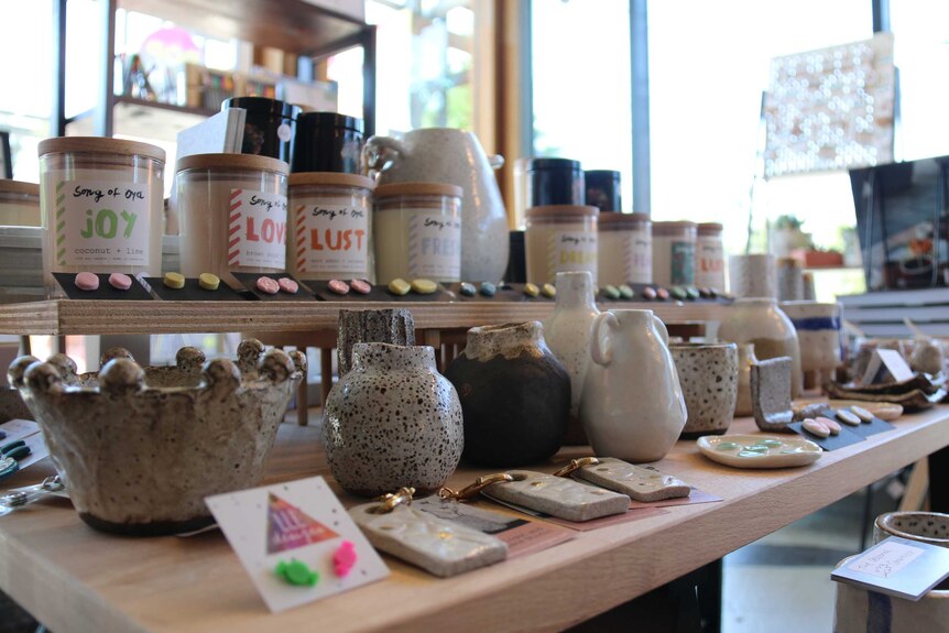 Ceramics, candles and jewellery line one of the tables at Pop CBR.