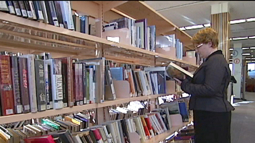 State Library shelves and librarian