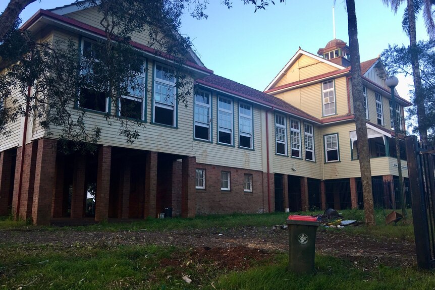 Abandoned school campus with empty buildings.