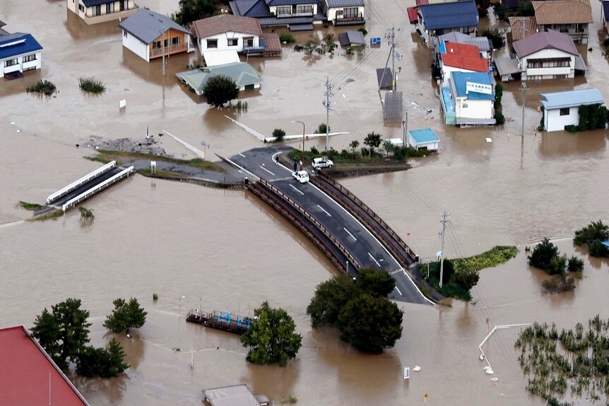 a flooded road and neighbourhood in Japan after Typhoon Hagibis hit.